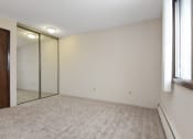 Thumbnail 12 of 41 - a bedroom with a large mirror and a carpeted floor. Roseville, MN Rosedale Estates