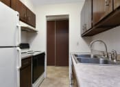 Thumbnail 9 of 41 - a kitchen with a sink and a refrigerator and a door. Roseville, MN Rosedale Estates