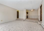 Thumbnail 8 of 41 - the living room of an empty house with carpet and a ceiling fan. Roseville, MN Rosedale Estates