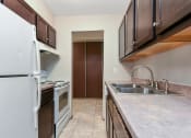 Thumbnail 19 of 41 - a kitchen with a sink and a refrigerator and a stove. Roseville, MN Rosedale Estates