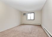 Thumbnail 17 of 41 - an empty living room with carpet and a window. Roseville, MN Rosedale Estates