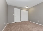 Thumbnail 18 of 41 - an empty room with carpet and two closet doors. Roseville, MN Rosedale Estates