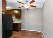 Thumbnail 16 of 41 - an empty kitchen with a ceiling fan and a refrigerator. Roseville, MN Rosedale Estates