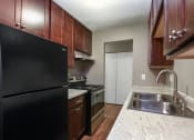 Thumbnail 15 of 41 - a kitchen with a sink and a stove and a refrigerator. Roseville, MN Rosedale Estates