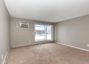 Thumbnail 14 of 41 - an empty living room with a large window. Roseville, MN Rosedale Estates