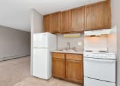 Thumbnail 23 of 41 - an empty kitchen with white appliances and wooden cabinets. Roseville, MN Rosedale Estates