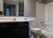 Thumbnail 36 of 41 - an empty bathroom with a toilet sink and tub. Roseville, MN Rosedale Estates Apartments