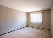 Thumbnail 30 of 41 - a bedroom of an empty house with a window. Roseville, MN Rosedale Estates Apartments