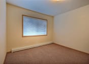 Thumbnail 7 of 18 - a bedroom with a window and a carpet. Moorhead, MN Sandy Creek Apartments