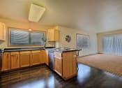 Thumbnail 6 of 18 - a kitchen with wooden cabinets and a counter top. Moorhead, MN Sandy Creek Apartments