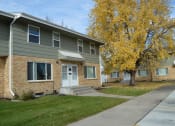 Thumbnail 26 of 28 - an apartment building with a sidewalk and a tree. Fargo, ND Sheyenne Terrace