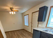 Thumbnail 24 of 28 - an empty kitchen with wood flooring in an empty house. Fargo, ND Sheyenne Terrace