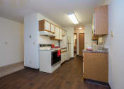 Thumbnail 8 of 19 - a kitchen with white appliances and wooden cabinets. Fargo, ND South Pointe Apartments