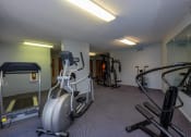 Thumbnail 18 of 19 - a gym with treadmills and other exercise equipment. Fargo, ND South Pointe Apartments