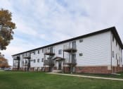Thumbnail 17 of 17 - The exterior of a three level apartment building with a grass area out front. Fargo, ND Southgate Apartments