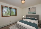 Thumbnail 4 of 19 - a bedroom with a bed and window. Fargo, ND South Pointe Apartments