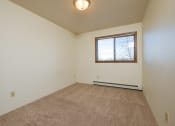 Thumbnail 17 of 19 - a bedroom with a window. Fargo, ND South Pointe Apartments