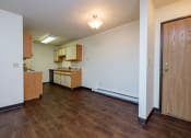 Thumbnail 14 of 19 - a dining room with a kitchen in the background. Fargo, ND South Pointe Apartments