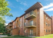 Thumbnail 23 of 25 - a brick apartment building with balconies and a blue sky. Fargo, ND Southview Village Apartments