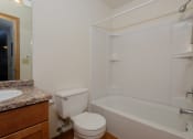 Thumbnail 9 of 10 - a bathroom with a sink and a toilet and a shower. Fargo, ND Southwind Apartments