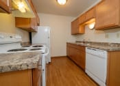 Thumbnail 6 of 10 - a kitchen with white appliances and wooden cabinets. Fargo, ND Southwind Apartments