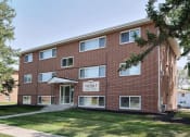 Thumbnail 1 of 14 - a brick building with a sidewalk in front of it. Fargo, ND Spring Apartments
