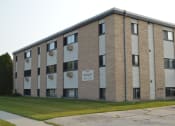 Thumbnail 14 of 14 - a brick building with a sign on the side of it. Fargo, ND Spring Apartments