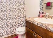 Thumbnail 9 of 10 - a bathroom with a shower toilet and sink. Grand Forks, ND Stanford Court Apartments