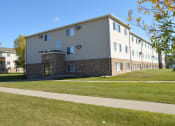 Thumbnail 10 of 10 - an apartment building with a sidewalk in front of it. Fargo, ND Sterling Park Apartments