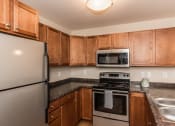 Thumbnail 12 of 19 - Grand Forks Sterling Pointe Apartments. A kitchen with stainless steel appliances