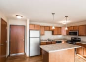 Thumbnail 10 of 19 - Grand Forks Sterling Pointe Apartments. A kitchen with stainless steel appliances