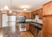Thumbnail 9 of 19 - Grand Forks Sterling Pointe Apartments. A kitchen with stainless steel appliances