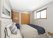 Thumbnail 6 of 14 - St. Louis Park, MN Courtyard Apartments. A  bedroom in st louis park at courtyard apartments with a bed and a window.