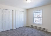 Thumbnail 31 of 43 - a bedroom with two doors and a window. Fargo, ND Stonebridge Apartments