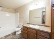 Thumbnail 12 of 16 - Bathroom with Large Mirror at Stonefield Apartments in Bismarck, ND