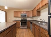 Thumbnail 8 of 16 - Fully Equipped Kitchen at Stonefield Apartments in Bismarck, ND
