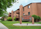 Thumbnail 1 of 10 - a large brick building with a sign in front of it