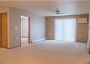 Thumbnail 2 of 5 - an empty living room with a ceiling fan and a closet.  Fargo, ND Summit Point Apartments