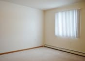 Thumbnail 5 of 5 - an empty room with a window and white walls.  Fargo, ND Summit Point Apartments