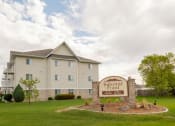 Thumbnail 1 of 5 - a three story apartment building with a sign out front. Fargo, ND Summit Point Apartments