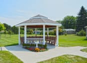 Thumbnail 19 of 21 - a gazebo with flowers and a large grassy area. Fargo, ND Sunrise North