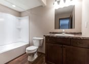 Thumbnail 12 of 27 - Grand Forks, ND Sunview apartments. a bathroom with a toilet sink and bathtub