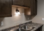 Thumbnail 9 of 27 - Grand Forks, ND Sunview Apartments. A close up of a sink with a light above it.