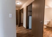 Thumbnail 13 of 27 - Grand Forks, ND Sunview apartments. a hallway with doors to bedrooms, a bathroom, and a closet