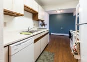 Thumbnail 15 of 27 - Grand Forks, ND Sunview apartments. a kitchen with white cabinets and a white dishwasher