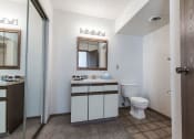 Thumbnail 25 of 27 - Grand Forks, ND Sunview apartments. a bathroom with a toilet sink mirror and shower