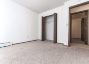 Thumbnail 20 of 27 - Grand Forks, ND Sunview apartments. a bedroom with white walls and a carpeted floor