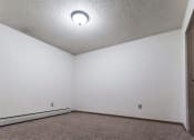 Thumbnail 21 of 27 - Grand Forks, ND Sunview apartments. a small empty room with white walls and carpet