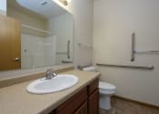 Thumbnail 9 of 23 - a bathroom with sink toilet and mirror. Fargo, ND North Sky Apartments
