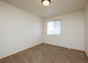 Thumbnail 17 of 28 - a spacious living room with carpet and a window Fargo, ND Thunder Creek Apartments